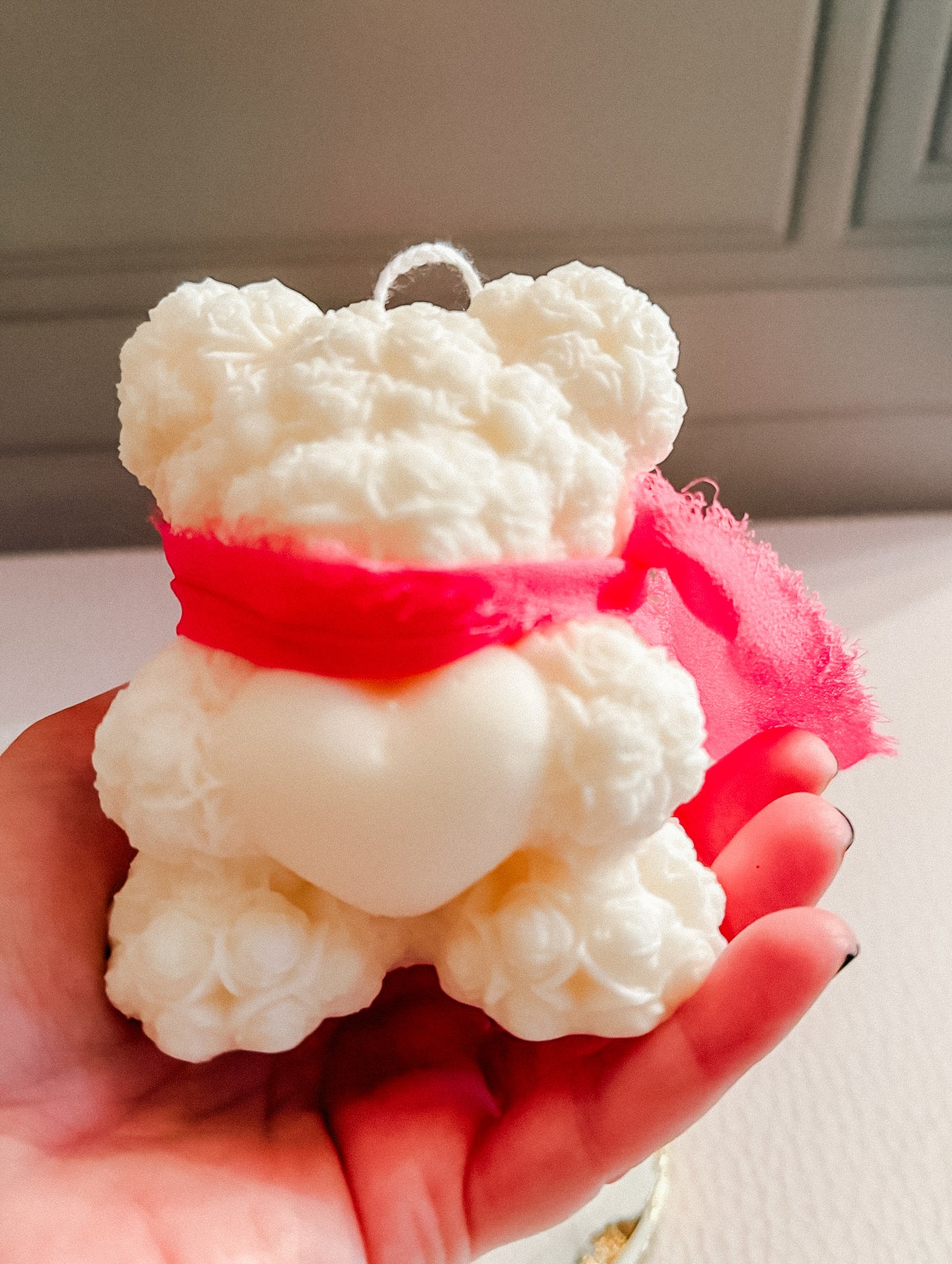 Heart holding bear candle with scarf